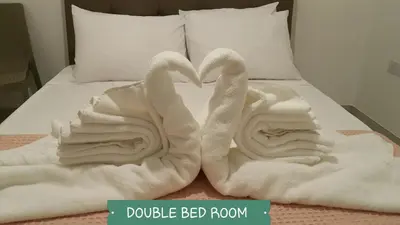 two swans made out of towels on a bed at CHRIS'S KYKLADES HOLIDAY APARTMENT in Paralimni