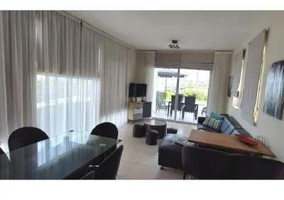 a living room with a glass table and a couch at Villa Sorelle in Protaras