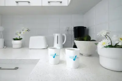a group of cups sitting on a counter with flowers at Villa Martha in Protaras