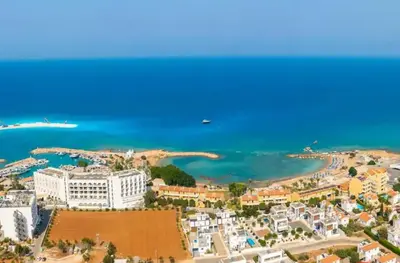 an aerial view of a beach with buildings and the ocean at Villa Martha in Protaras