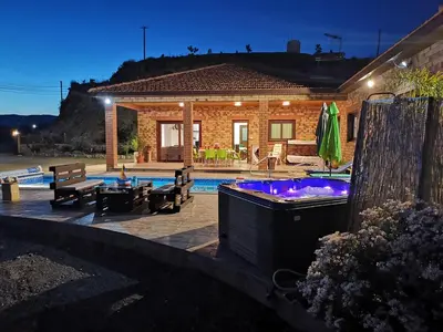 a house with a swimming pool with a hot tub at Kalamospito Holiday House in Kalokhorio