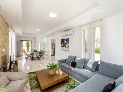 a living room with a couch and a table at Milos lifestyle villa H30 in Protaras