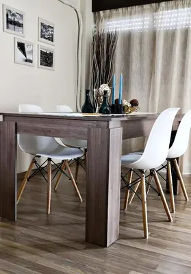 a dining room with a wooden table and white chairs at The Bridge-House Apartment in Nicosia
