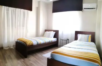a bedroom with two beds and a window at The Bridge-House Apartment in Nicosia