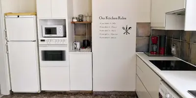 a kitchen with white appliances and white cabinets at The Bridge-House Apartment in Nicosia