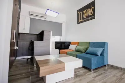 a living room with a couch and a table at Twins Apartments in Kato Pyrgos
