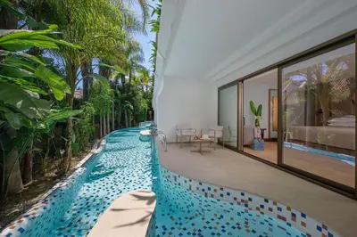 an infinity pool in a villa with a house at Four Seasons Hotel in Limassol