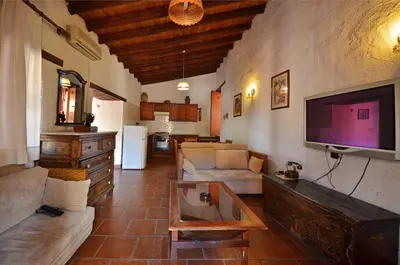 a living room with a couch and a tv at Linos Inn in Kakopetria