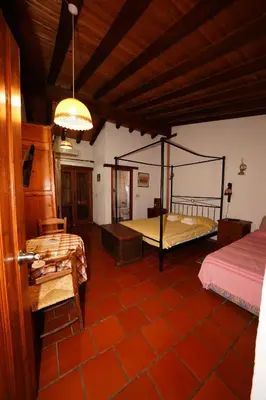 a room with a bedroom with a bed and a table at Linos Inn in Kakopetria
