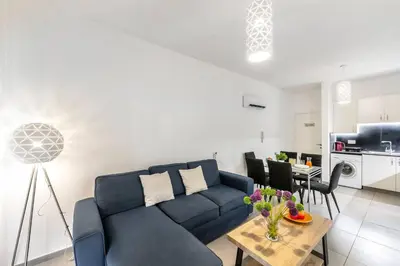 a living room with a blue couch and a table at AirBnSea City Centre Side Sea view Apartments in Larnaka