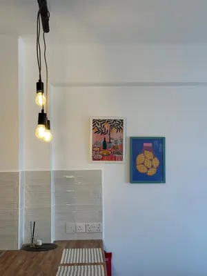 a white room with two pictures on the wall at Krasas Beach in Larnaka