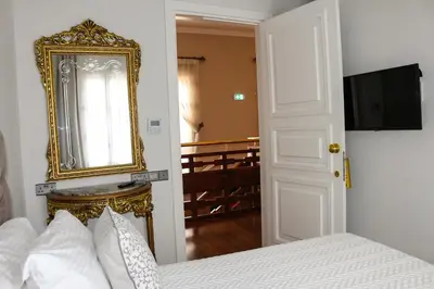 a bedroom with a bed and a mirror on the wall at 9 Muses Hotel in Larnaka