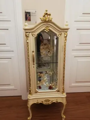 a gold grandfather clock sitting on the floor at 9 Muses Hotel in Larnaka