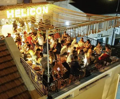 a crowd of people sitting at tables in a restaurant at 9 Muses Hotel in Larnaka