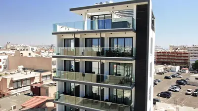a building with balconies on the side of it at Jimmy's Suites in Larnaka