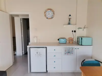 a kitchen with a white counter and a dishwasher at Lighthouse in Larnaka