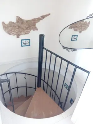 a spiral staircase with a plane on the wall at Lighthouse in Larnaka