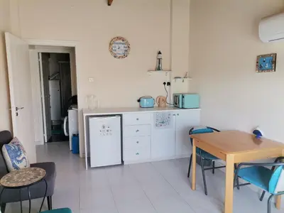 a kitchen with a table and a table and chairs at Lighthouse in Larnaka
