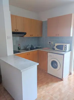 a kitchen with a washing machine and a microwave at Hawaii Royal Gardens 2 in Limassol