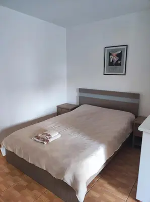 a bedroom with a large bed with a tan blanket at Hawaii Royal Gardens 2 in Limassol
