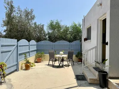 a patio with a table and chairs and a fence at Detached Cozy Studio in Paralimni