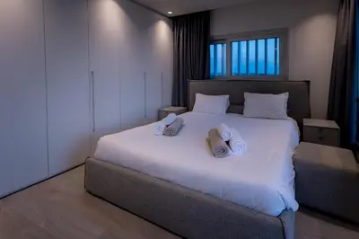 a bedroom with a large bed with two towels on it at Napa Hills Seaview Villas in Ayia Napa