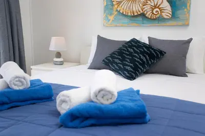 a bedroom with a bed with towels on it at White Arches Apt #1 by TrulyCyprus in Limassol