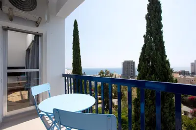 a balcony with a table and chairs and a view at White Arches Apt #1 by TrulyCyprus in Limassol