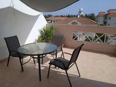 a glass table and chairs on a balcony at Xylophagou Larnaca Ayia Napa 1 bedroom apartment in Xylophaghou