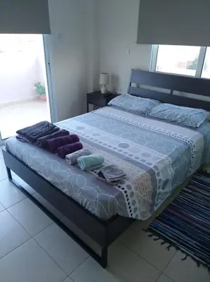 a bedroom with a large bed with towels on it at Xylophagou Larnaca Ayia Napa 1 bedroom apartment in Xylophaghou