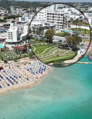 an aerial view of a beach with chairs and umbrellas at PALLINIO COURT 402 Fig Tree Bay- Protaras Beach, IASONOS STR 7A in Protaras