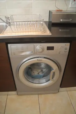 a washing machine with a basket on top of it at Kapparis Penthouse in Paralimni