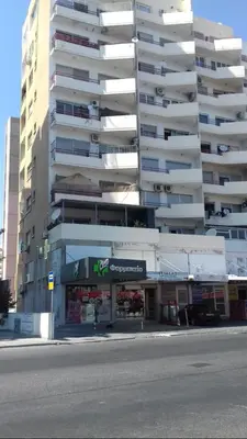 a large apartment building with a store in front of it at Great views apartment. in Limassol
