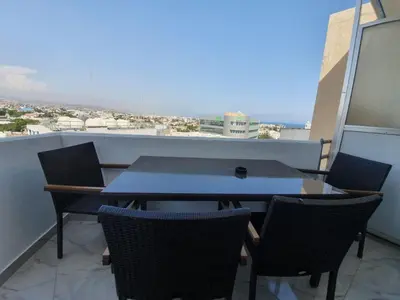 a table and chairs on a balcony with a view at Great views apartment. in Limassol