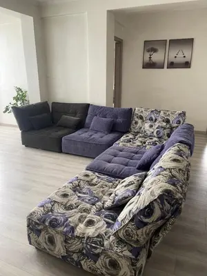 a living room with a couch and a blue couch at Galaxy court modern apartment in Limassol