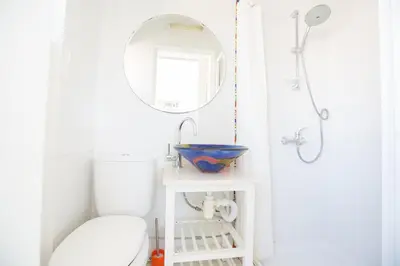 a bathroom with a white toilet and a mirror at Villa Papantonia in Protaras
