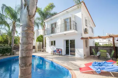 a villa with a swimming pool and a house at Villa Papantonia in Protaras