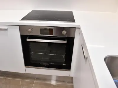 a kitchen with an oven in a white counter top at BAZ TOWER in Nicosia