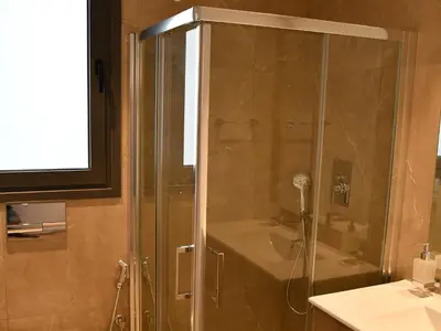 a shower with a glass door in a bathroom at BAZ TOWER in Nicosia