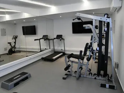 a gym with treadmills and exercise bikes in a room at BAZ TOWER in Nicosia