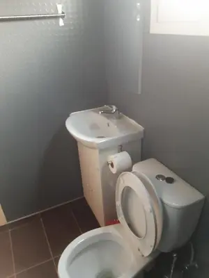 a bathroom with a white toilet and a sink at City Center Holiday room in Limassol