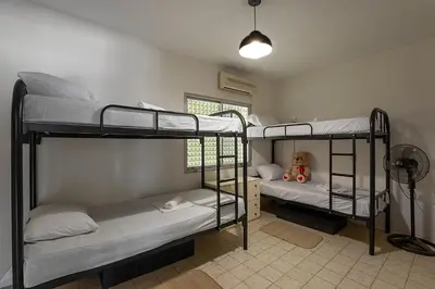 a room with three bunk beds in a room at White Hostel in Limassol