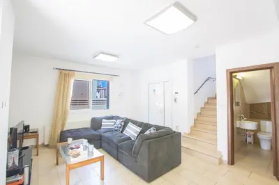 a living room with a couch and a staircase at Protaras View Villa 5 in Protaras
