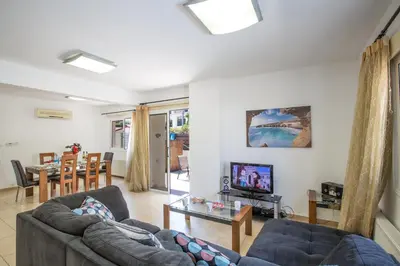 a living room with a couch and a table at Protaras View Villa 5 in Protaras