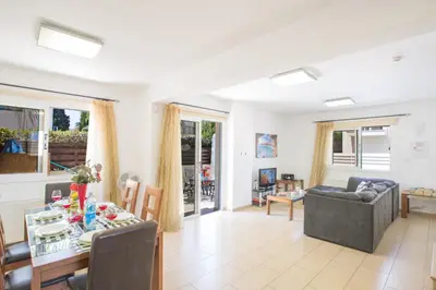 a living room with a table and a dining room at Protaras View Villa 5 in Protaras