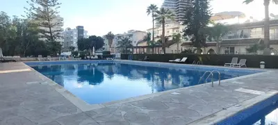 a swimming pool in the middle of a building at Palm beach 14 in Limassol