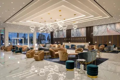 a lobby with couches and tables and chairs at Chrysomare Beach Hotel & Resort in Ayia Napa