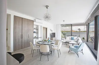 a living room with a table and chairs at Colour Residences in Protaras