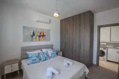 a bedroom with a bed with towels on it at Colour Residences in Protaras