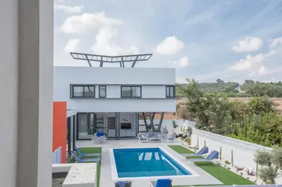 a villa with a swimming pool and a house at Colour Residences in Protaras